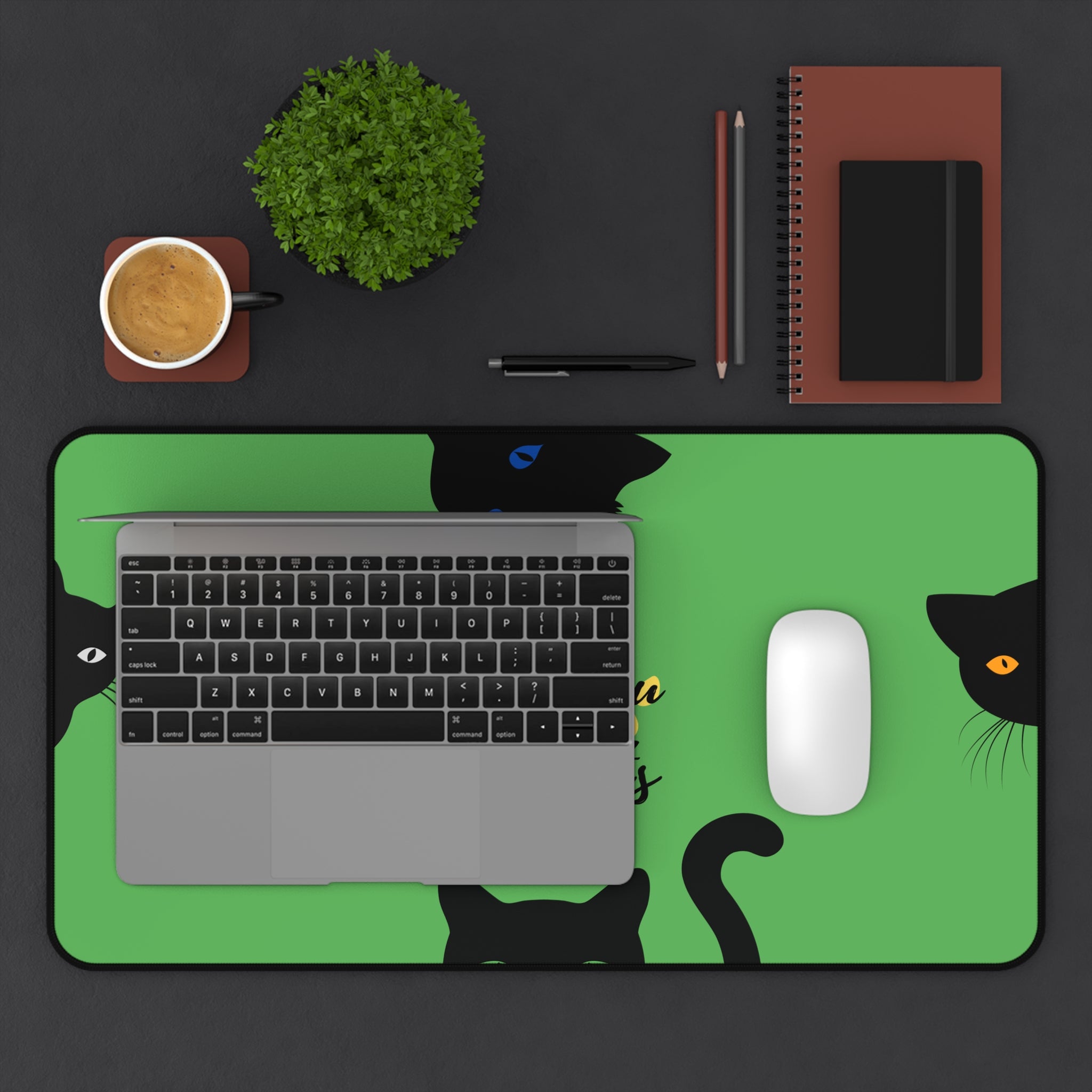 protective green desk mat with black cats and paw prints