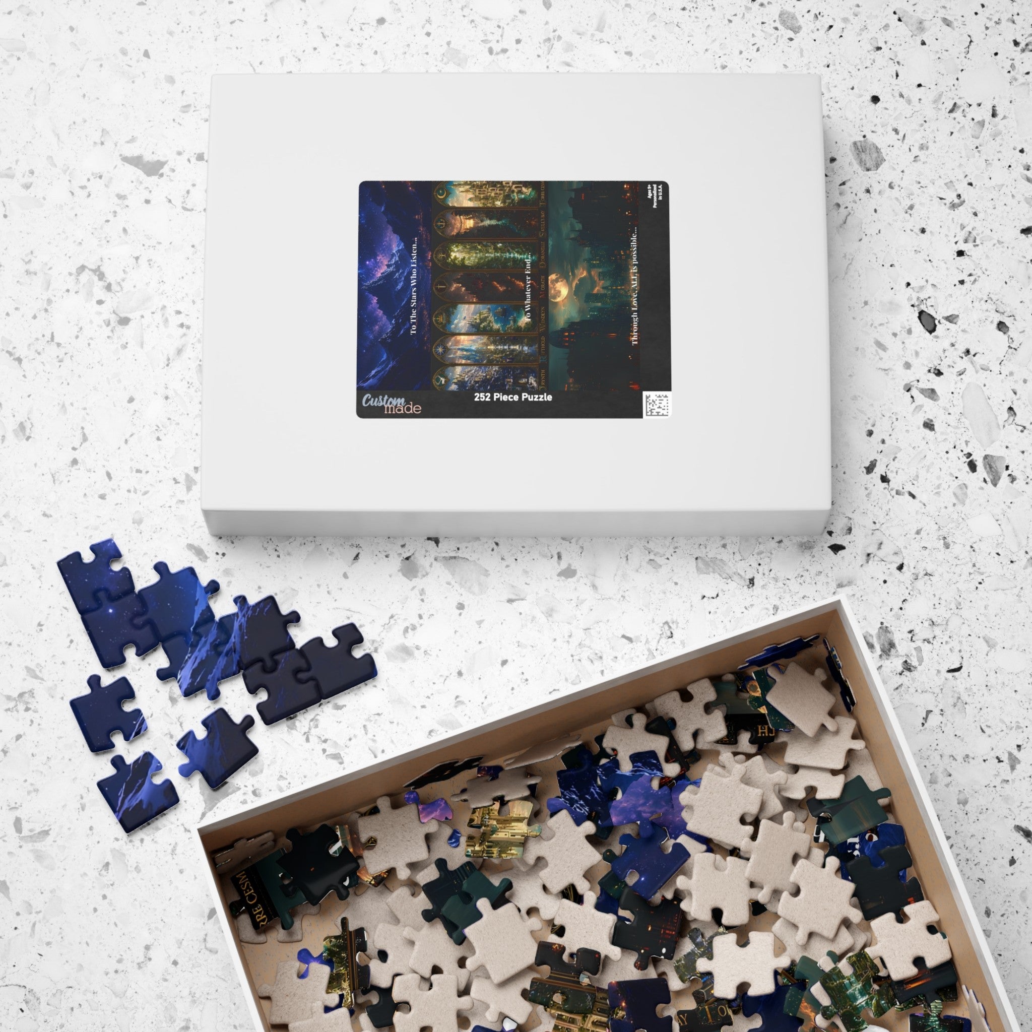 A jigsaw puzzle box shown on a light speckled surface, with the lid displaying a dark fantasy forest scene and the open box below filled with mixed puzzle pieces. Loose blue pieces sit to the left.