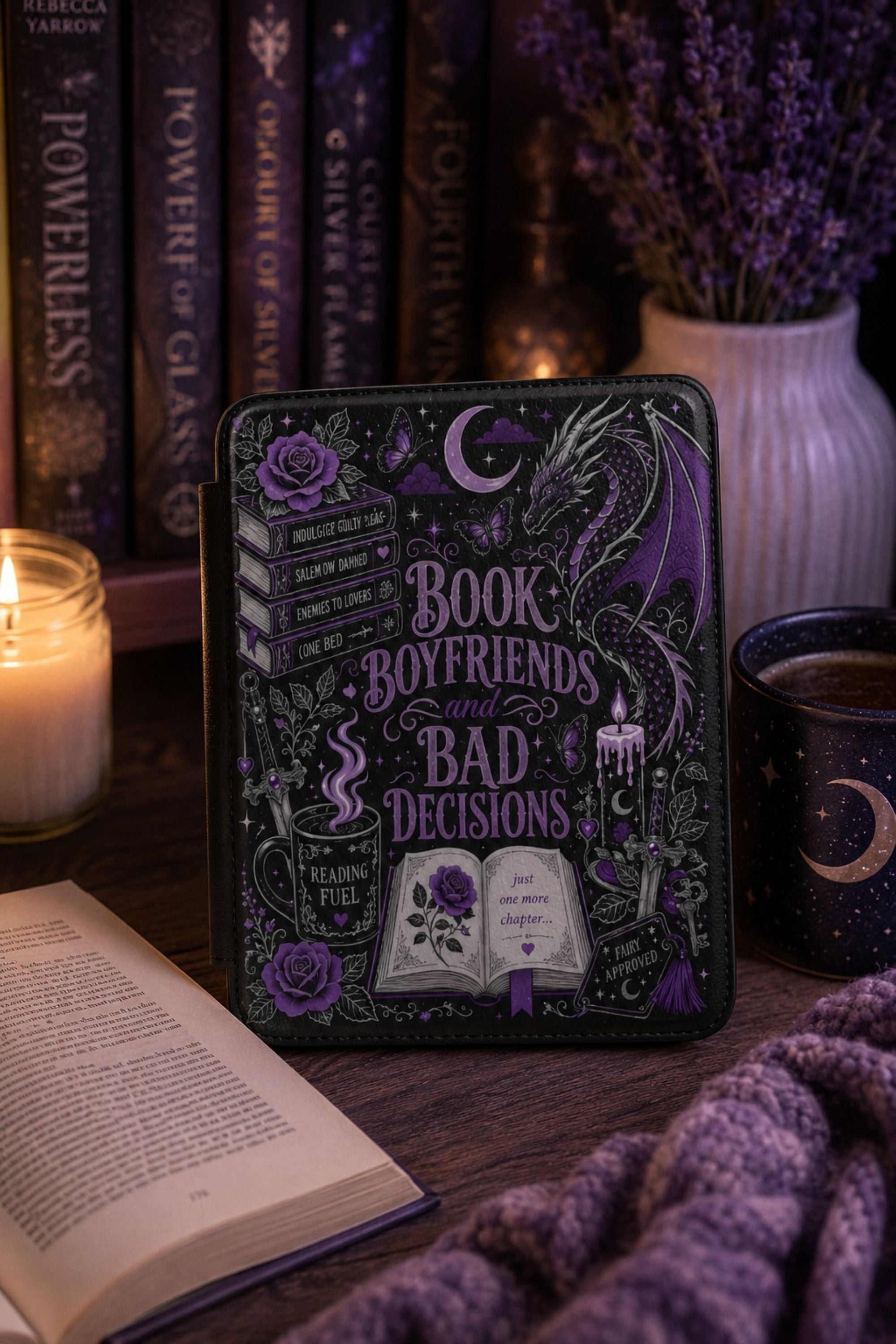 Kindle case styled with a lit taper candle, stacked books, and a steaming mug for a cozy gift flat lay