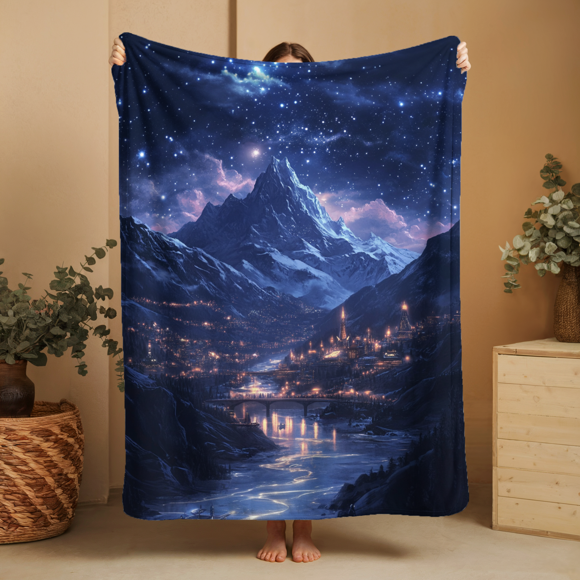 Cozy fleece blanket with starry mountain city design under a night sky
Woman holding celestial blanket with mountain and starlit sky artwork