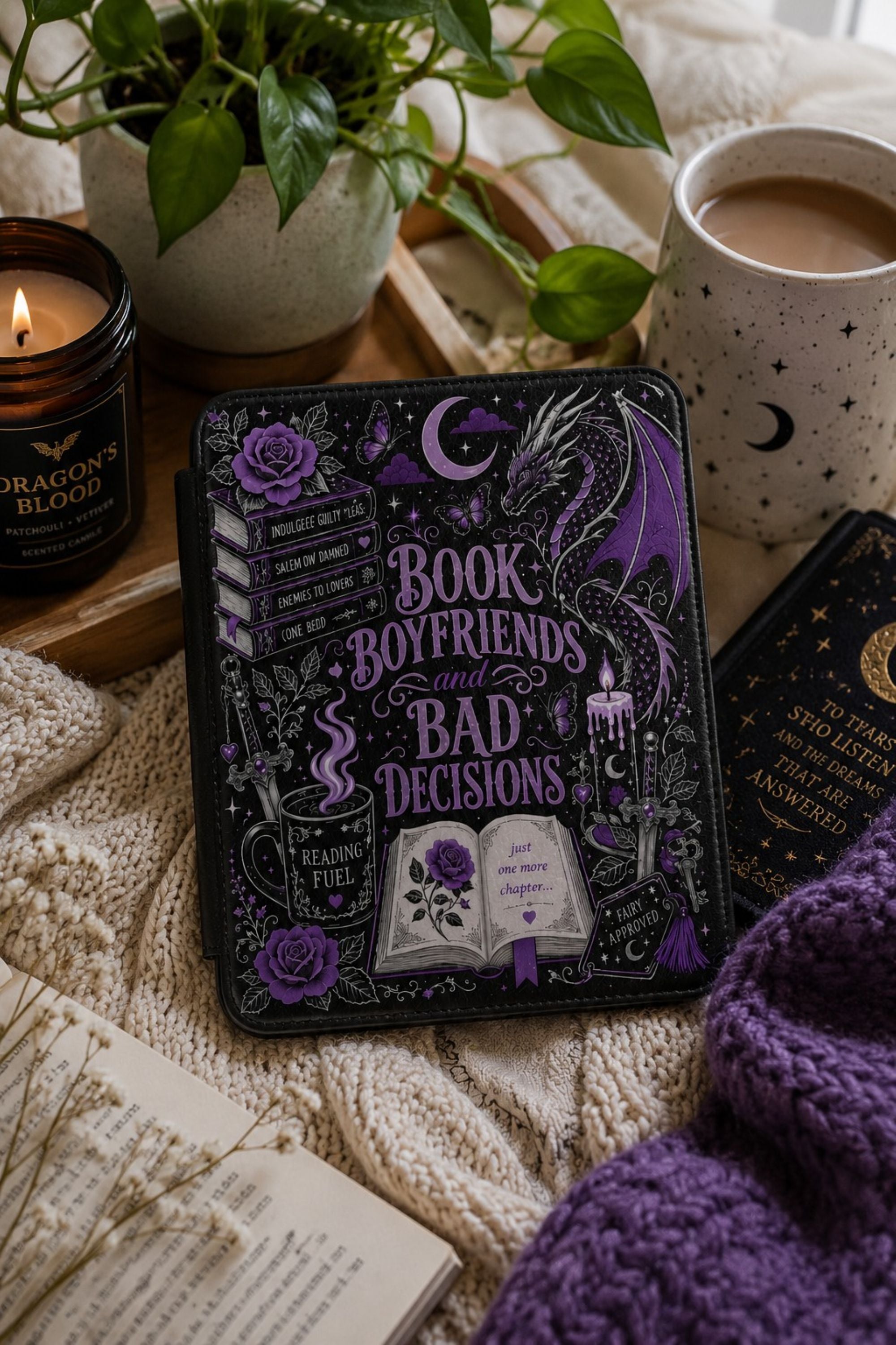 Kindle case styled with a lit taper candle, stacked books, and a steaming mug for a cozy gift flat lay