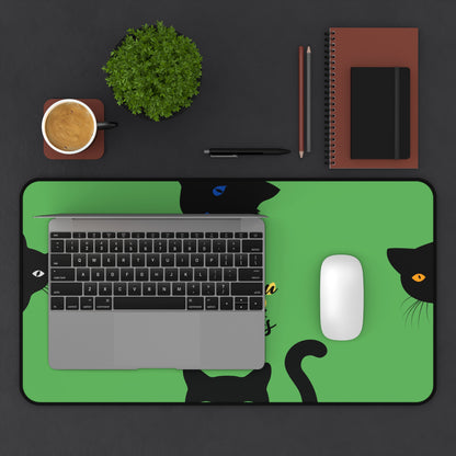 protective green desk mat with black cats and paw prints