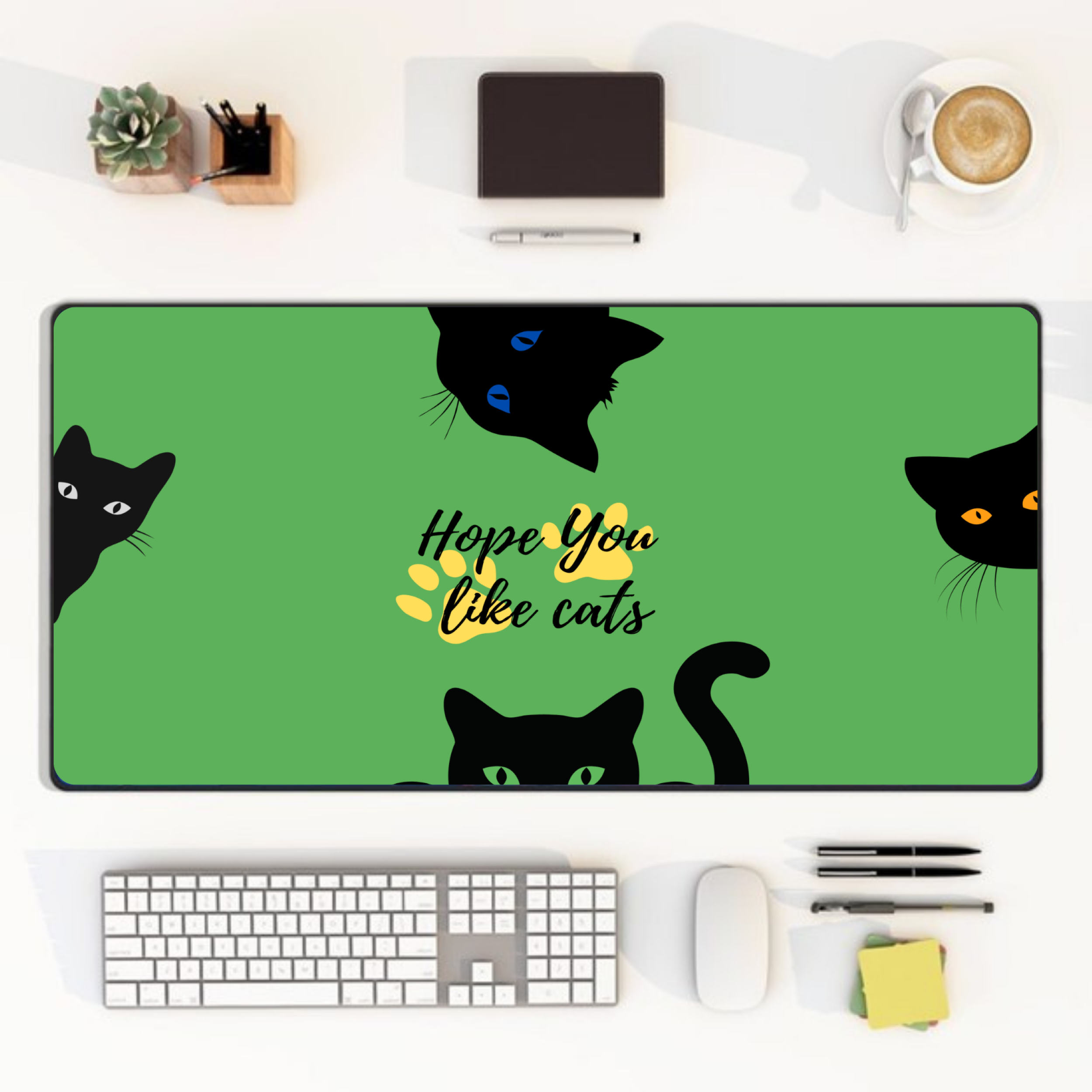 green cat desk mat with black cat faces and yellow paw print design
