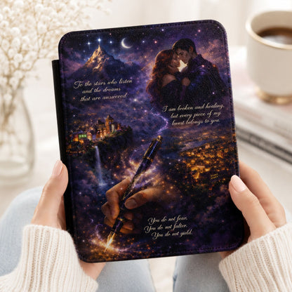 Woman holding Velaris Night Court Kindle case with starlit purple sky, embracing couple, and glowing city scene