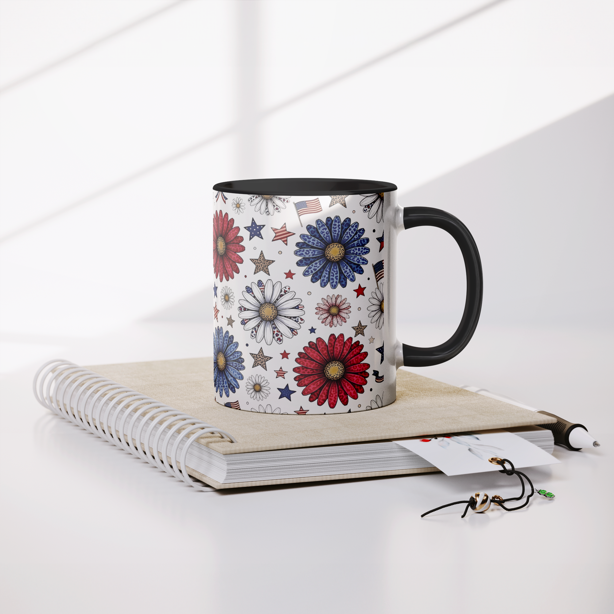 Daisy_and_flags_11oz_Black_Accent_Mug_Mug_Lifestyle_Notebook_Mockup.png_15743839