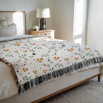 Cozy minimalist botanical tapestry blanket displayed outdoors on grass