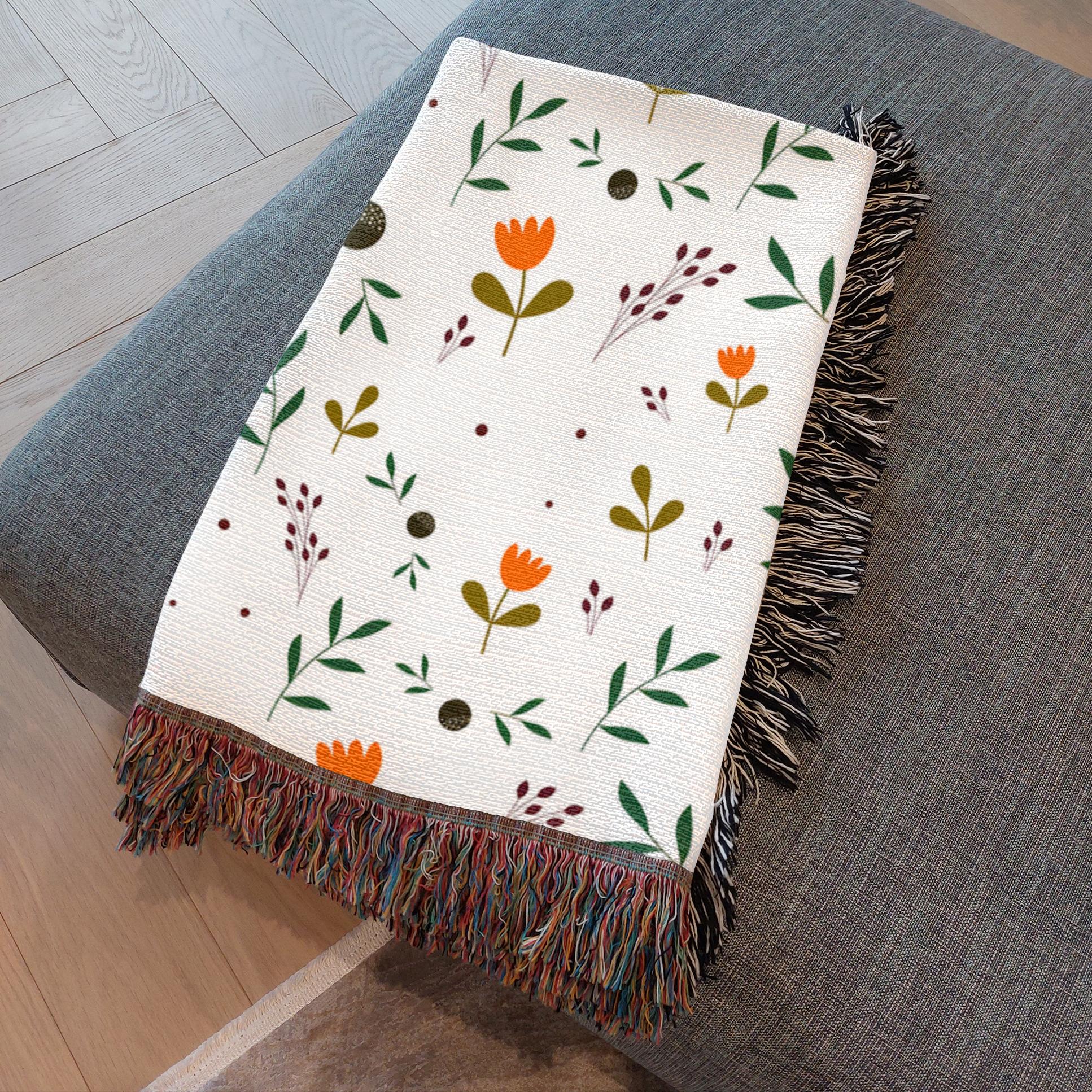 Folded boho throw blanket showcasing warm earth tones and botanical print